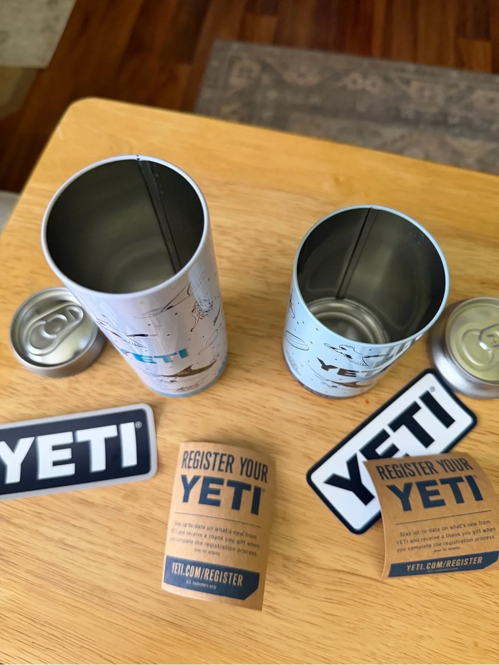Yeti Slim Can Coolers in Light Gray with Blue Logo Accents